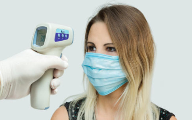 Temperature check before dental appointment at Elegant Smiles Dentistry Atlanta, GA.